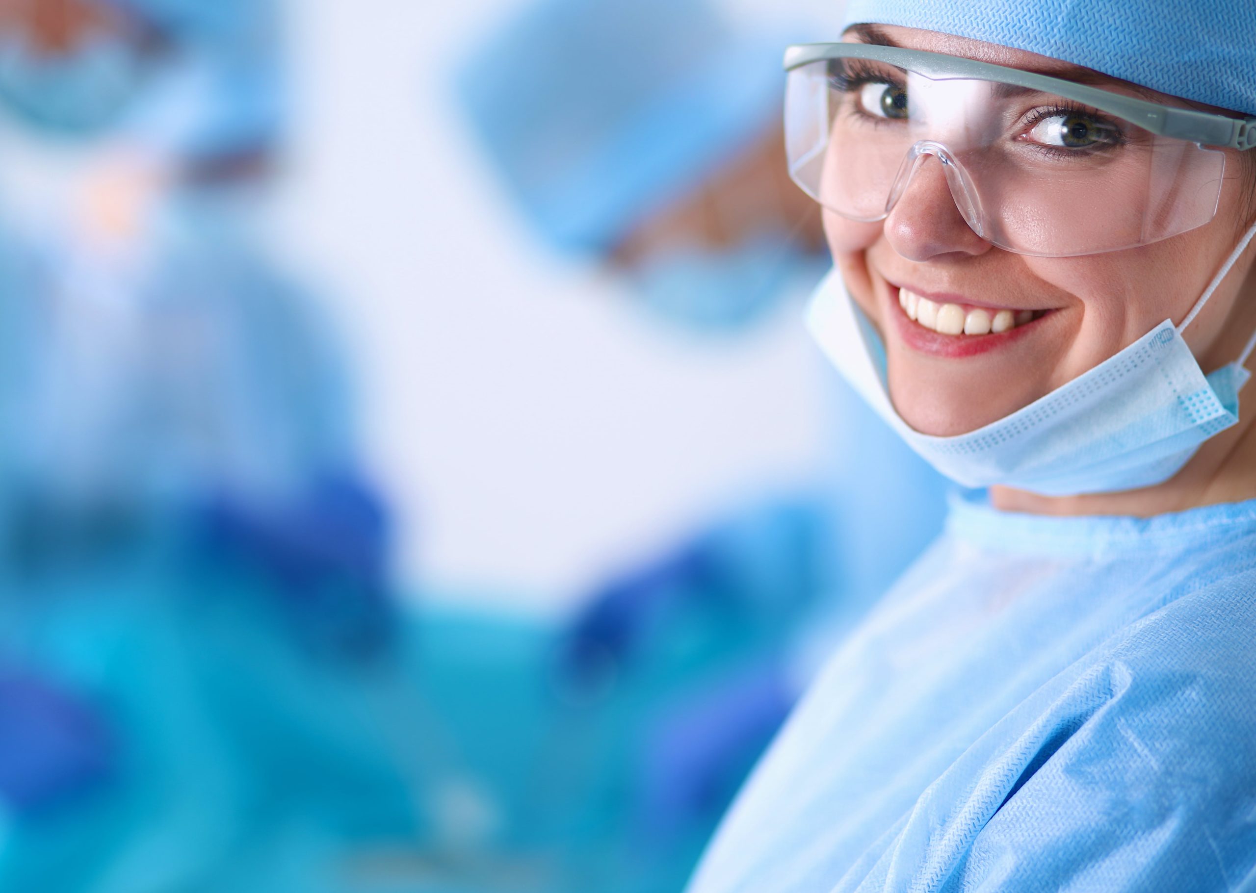 A nurse smiling in her scrubs.