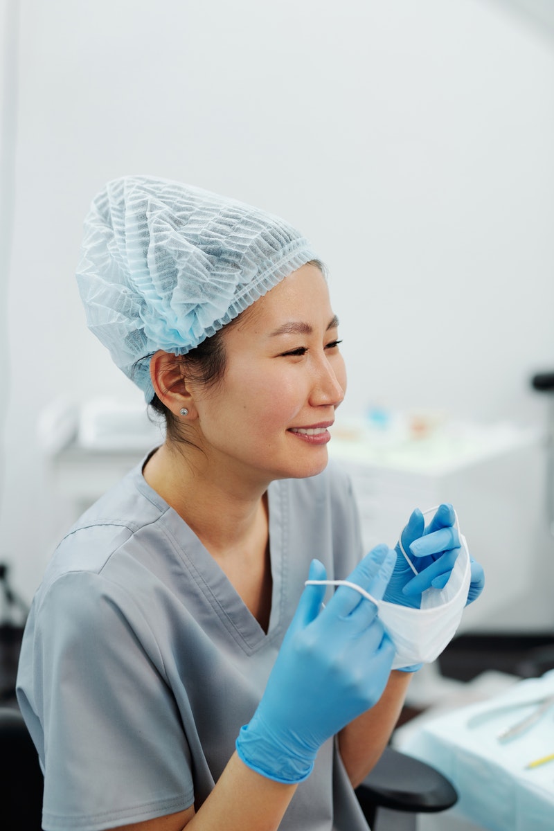 A Traveling Nurse Wearing a Scrub Suit and Hair Net