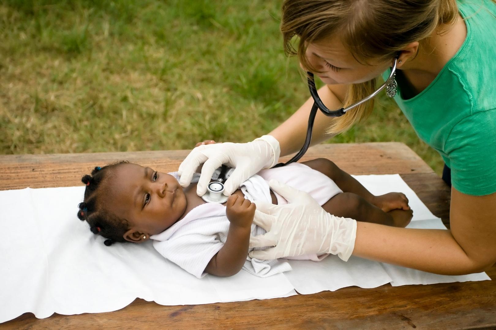 An NICU nurse checking a baby.